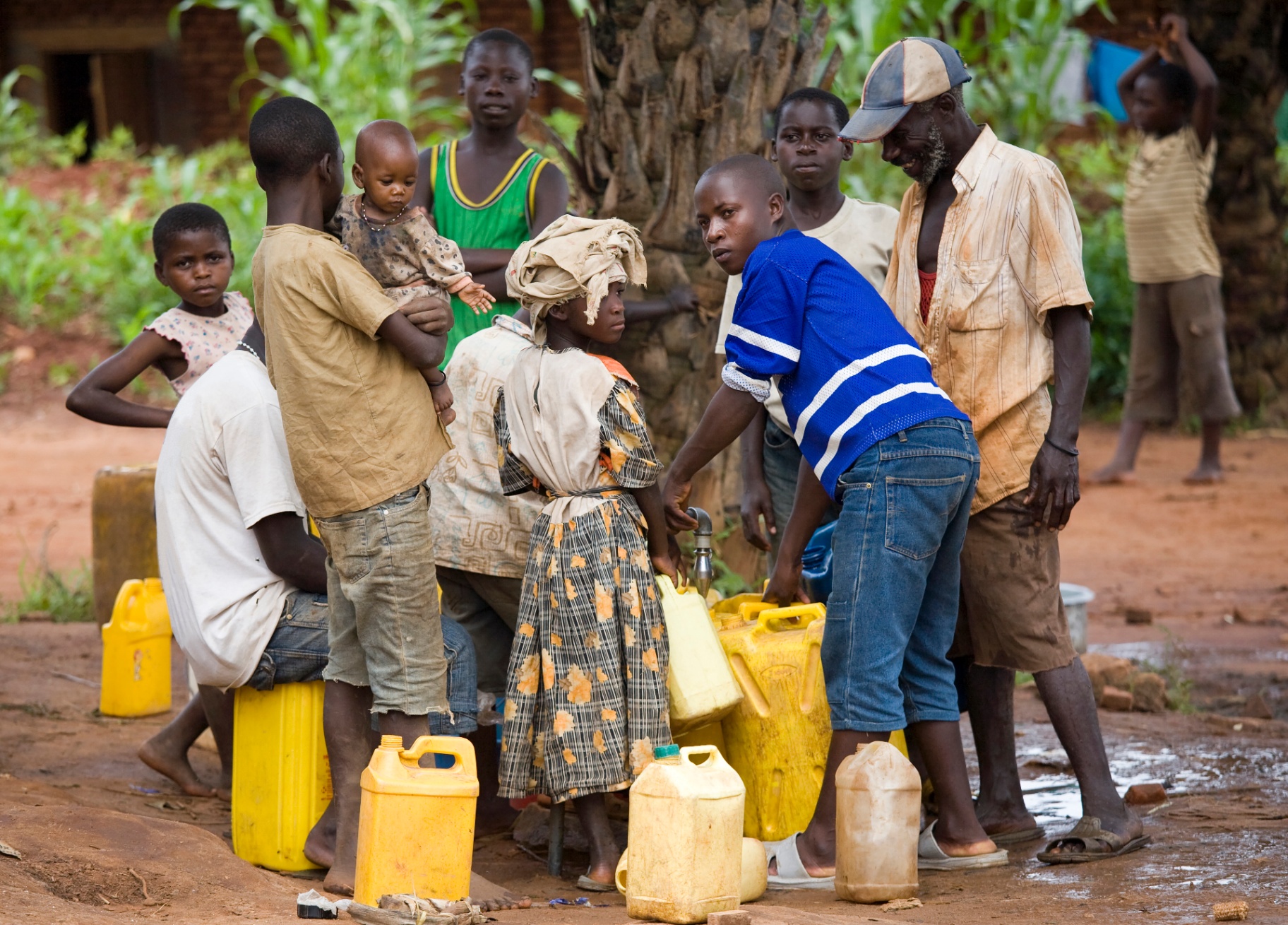 Community members gathered around a shared water point in rural Kenya